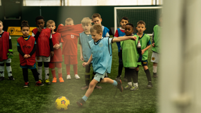 Boy Blue Bib Kicking Ball